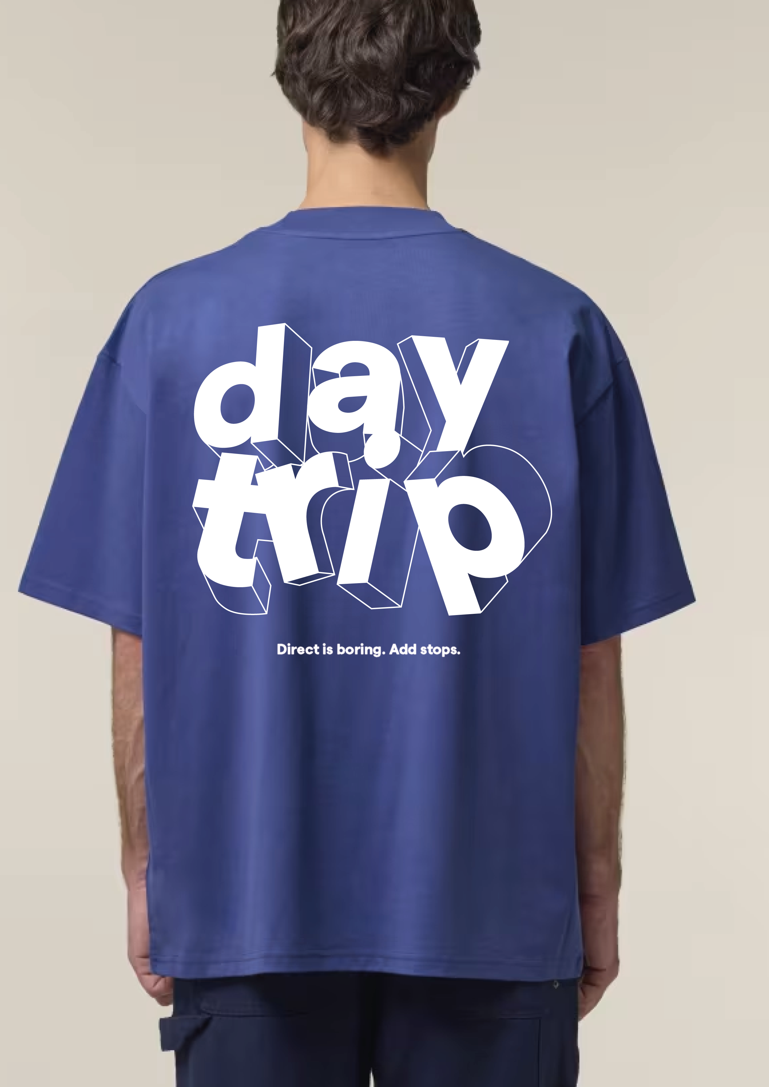 Daytrip branded t-shirt worn in a lifestyle photo, reading 'Direct is boring. Add stops.'